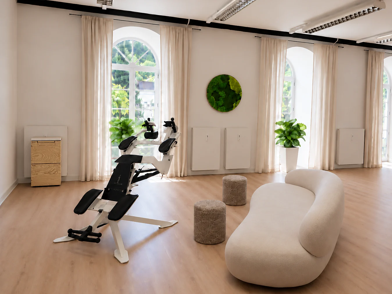Training room with the ICAROS device and a sofa in front of the arched windows